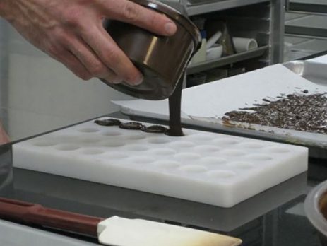 Pouring the black forest chocolate into moulds